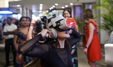 Woman wearing virtual reality headset in crowded room