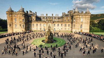 Large group of dancers outside The Palace of Holyrood