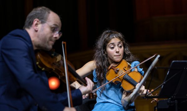 a man and woman play violin