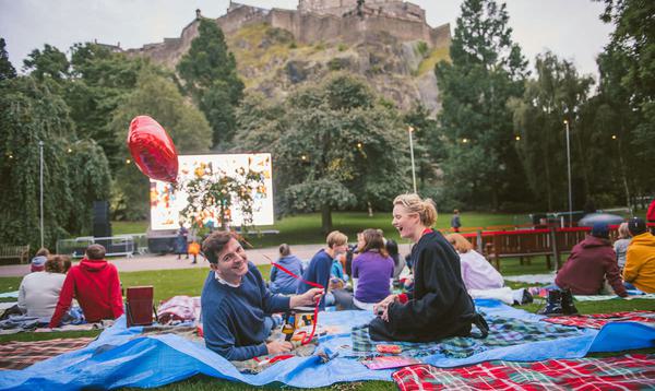 Couples sat on blankets in Princess Street Garden