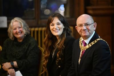 Nicola Benedetti and The Lord Provost sit next to one another smiling at something off camera.