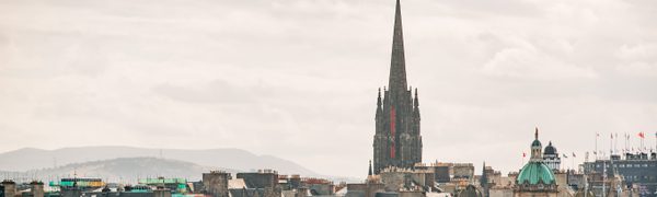 An Edinburgh skyline featuring the gothic spire of The Hub.