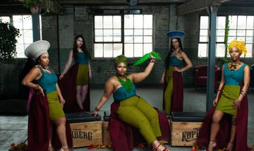 The women of Shona the Musical Choir pose, wearing African wax print clothing