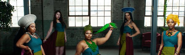 The women of Shona the Musical Choir pose, wearing African wax print clothing