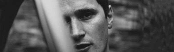 A black and white close up of Erland Cooper