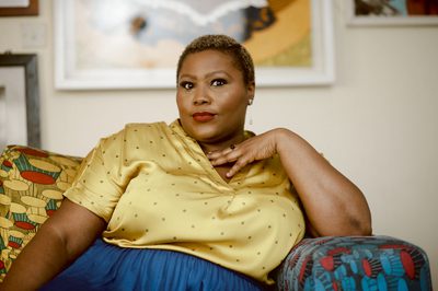 Wana Odubang pictured wearing a gold shirt and blue skirt