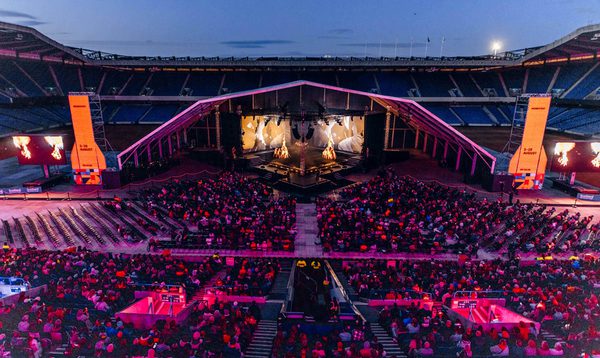 A view overlooking the stalls of Murrayfield Stadium to a stage on the pitch.