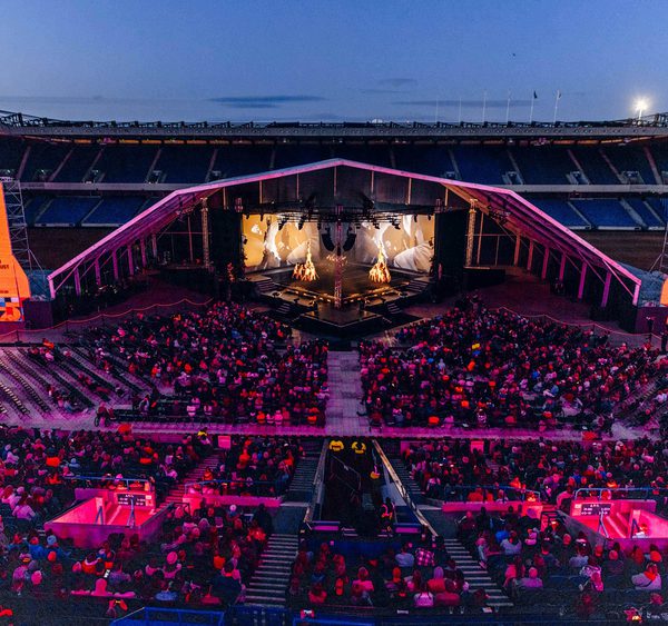 A view overlooking the stalls of Murrayfield Stadium to a stage on the pitch.
