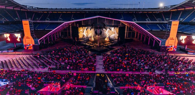 A view overlooking the stalls of Murrayfield Stadium to a stage on the pitch.