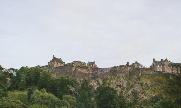 A view from below of Edinburgh Castle against a blue sky