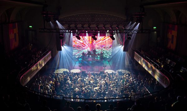 The view from the back of the gallery in Leith Theatre overlooking a full crowd and a DJ on stage