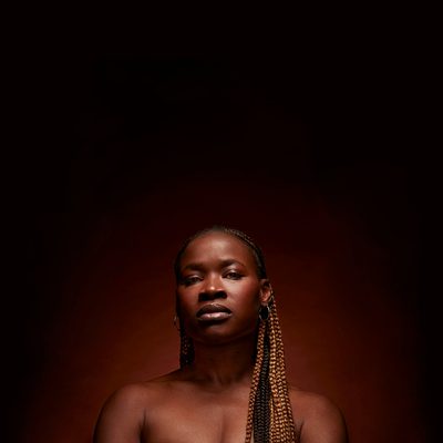 Adura Onashile pictured from the shoulders up, looking directly into the camera with an unflinching gaze.