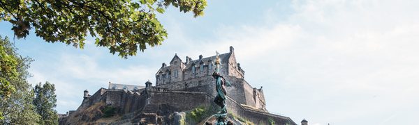 The view of Edinburgh Castle from Princes Street Gardens, with the fountain spraying water in the foreground