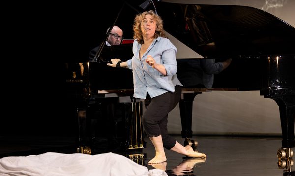 A singer dances on the stage, her expression is mournful