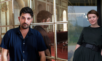 On the left, a man with short black hair and stubble leans against a vintage mirror and looks at the camera. On the right, a woman with short brown hair, in a dark green dress leans against a galvanised iron wall and looks directly at the camera.