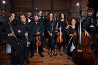 The members of Chineke! Orchestra stand with their classical instruments