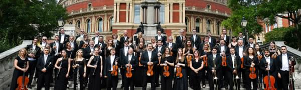The Royal Philharmonic Orchestra stand in front of the Royal Albert Hall on a sunny day