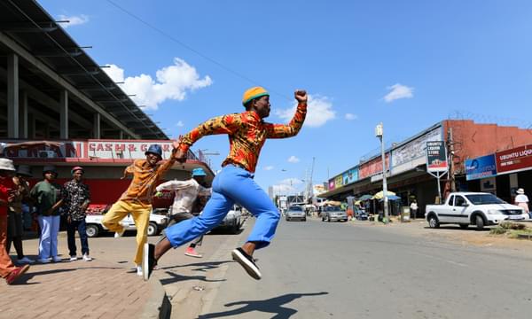 A man jumps as if running mid-air in Soweto, South Africa.