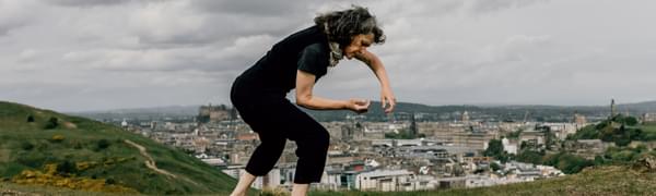 Janice Parker dances on a hill overlooking Edinburgh