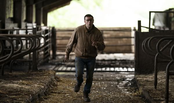 Man runs through a barn