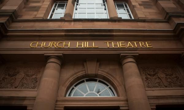 The front of Church Hill Theatre, a pink sandstone building with columns
