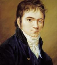A painting of the composer as a young man, with dark hair, sideburns and a serious expression, wearing a high white collared shirt and blue velvet jacket.