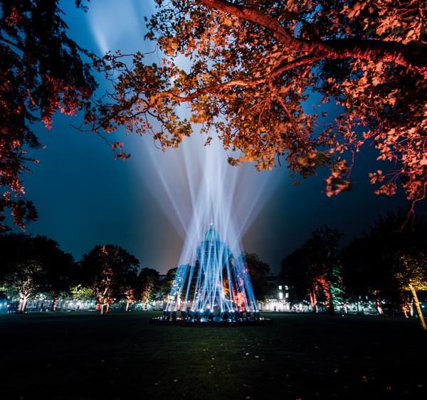 Beams of light form a pyramid in the centre of Charlotte Square, with illuminated trees grouped around the outskirts.