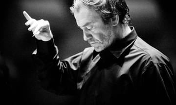 A black and white image of Valery Gergiev conducting